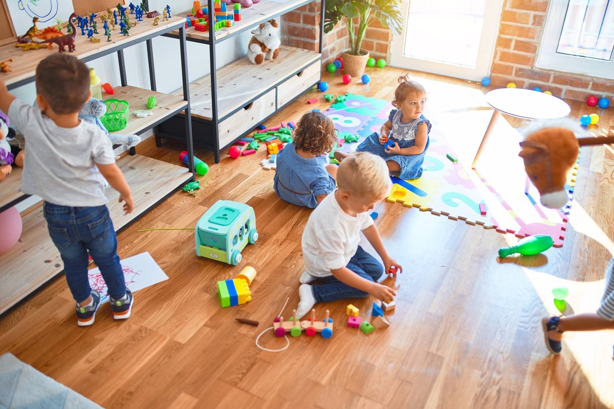 Children playing with toys on soft floor
